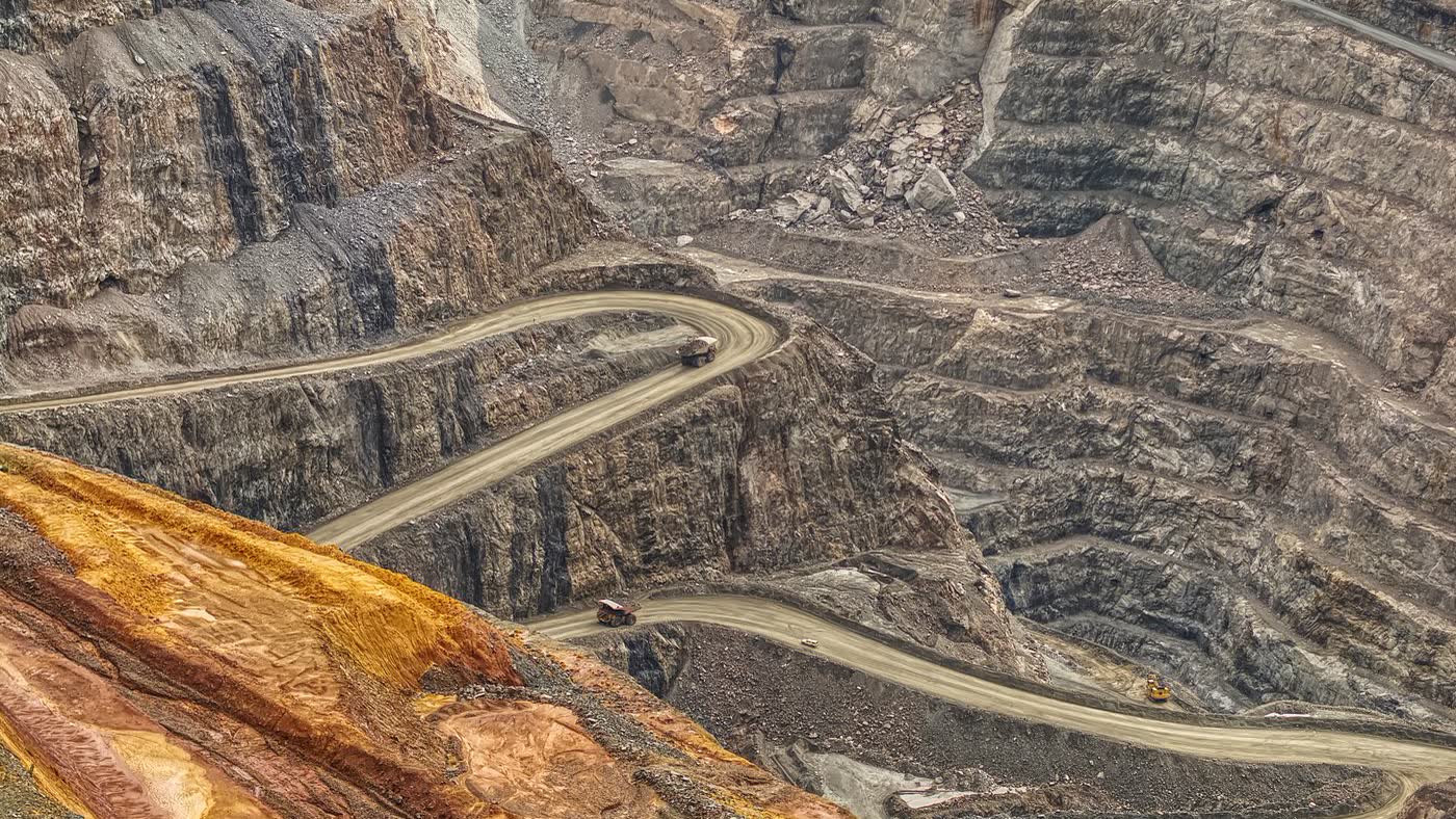Aerial view of an open-cut mine, with haul roads cut in terraces around the pit.