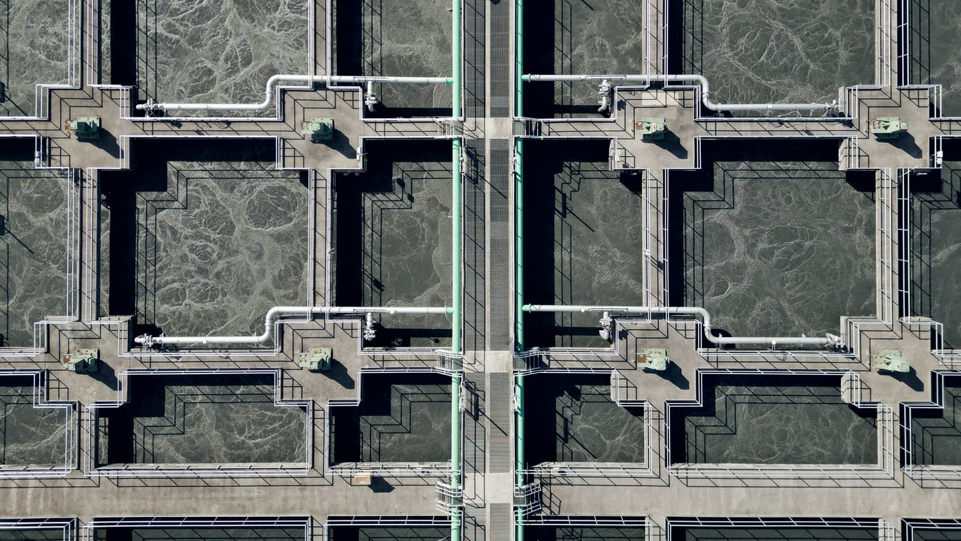 Aerial view of rectangular sedimentation and clarifier basins at a water treatment facility.